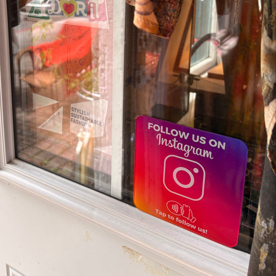 1TapMETA Instagram NFC tile mounted on the glass door of Adorit Boutique in Ottawa's ByWard Market